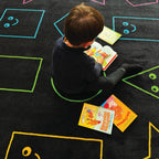 ZETY children's classroom rug in nylon, 7.6 x 12 ft, pastel smiley faces on black