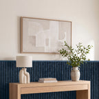 Blue wainscoting panels running along a bedroom wall with coordinating top molding