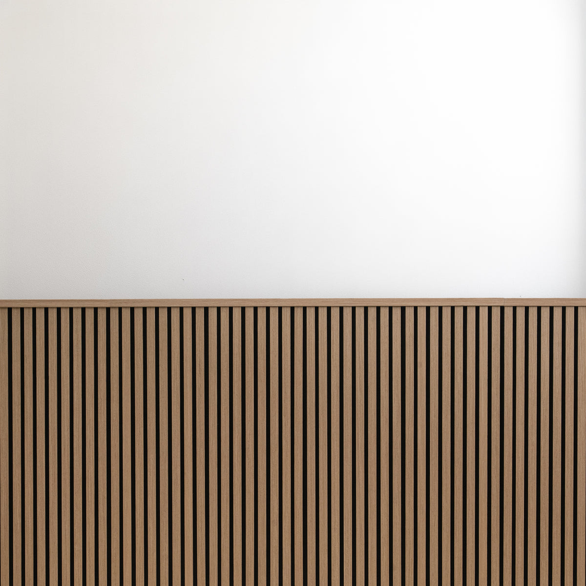 Oak wainscot slat panels finished with top molding against a white upper wall