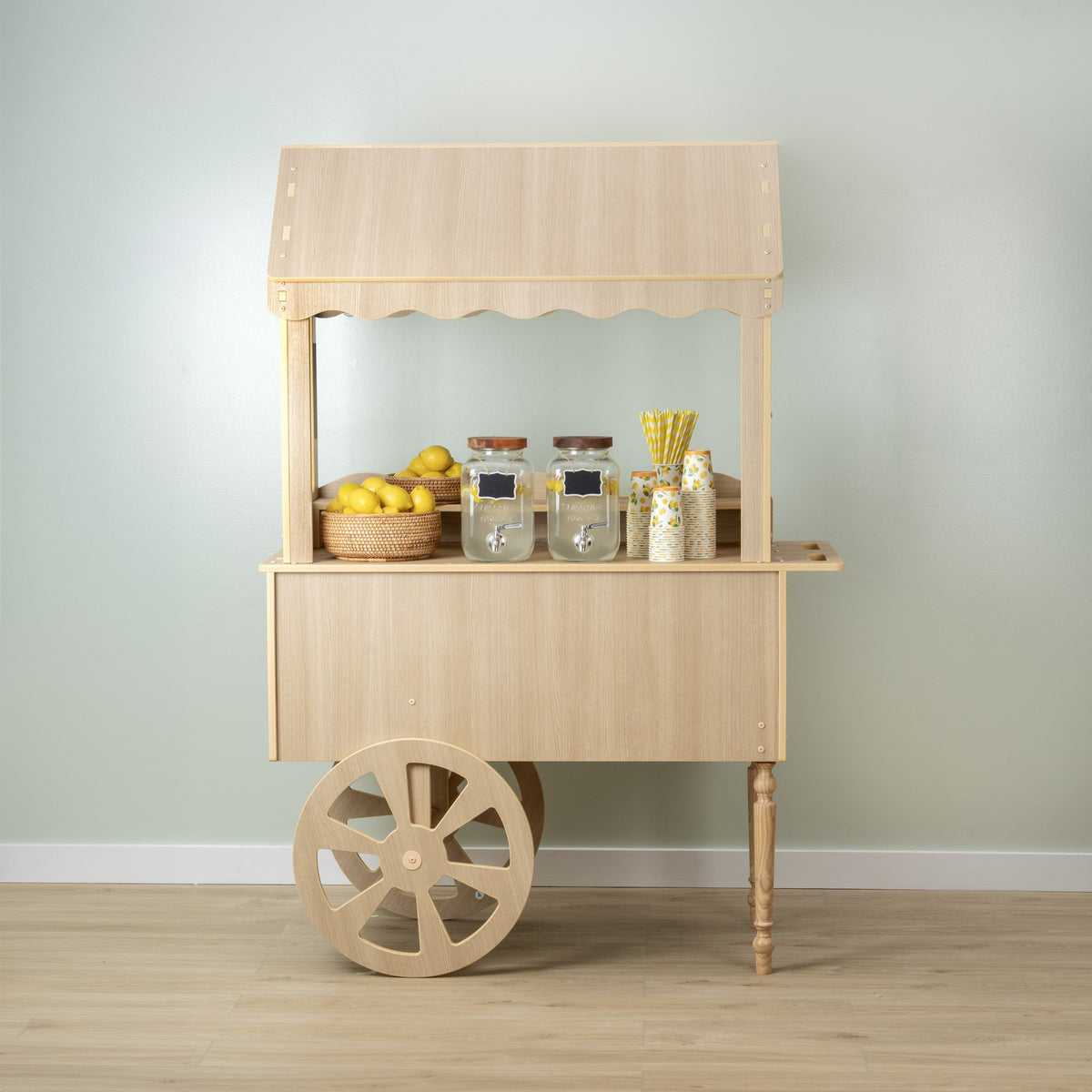 Wood-look candy cart with canopy, counter and spoked wheels styled with candy jars