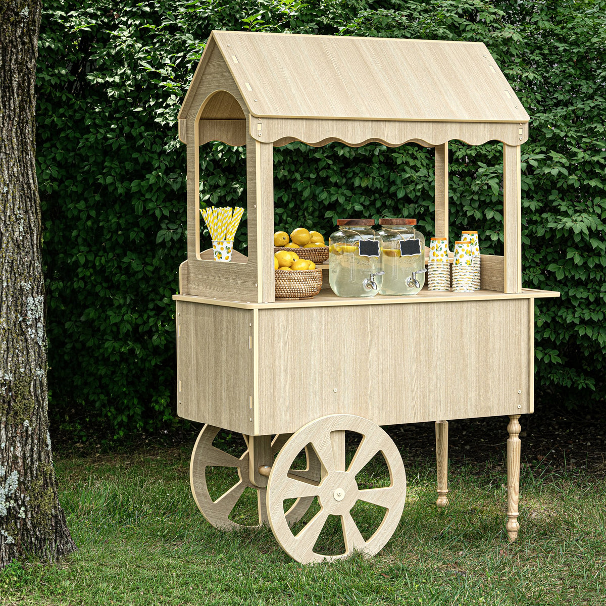 Wood-look candy cart set up outdoors on grass, front view with canopy and valance