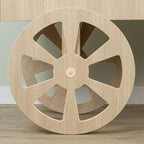 Detail of the large spoked front wheel on the wood-look candy cart