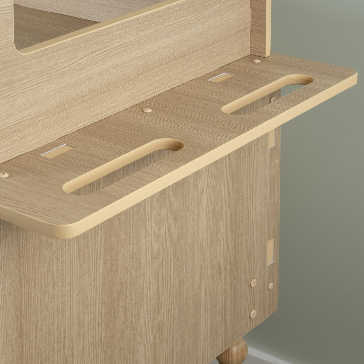 Detail of the shelf slot and bracket on the candy cart frame